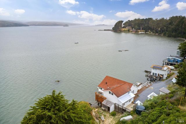 an aerial view of a house with a lake view