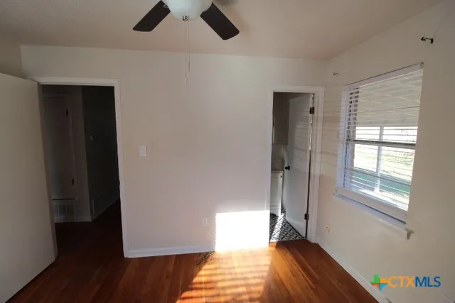 wooden floor in an empty room with a window