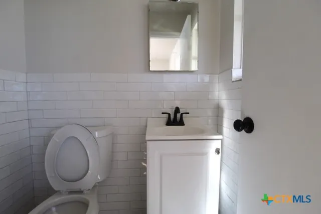 a bathroom with a toilet and a sink