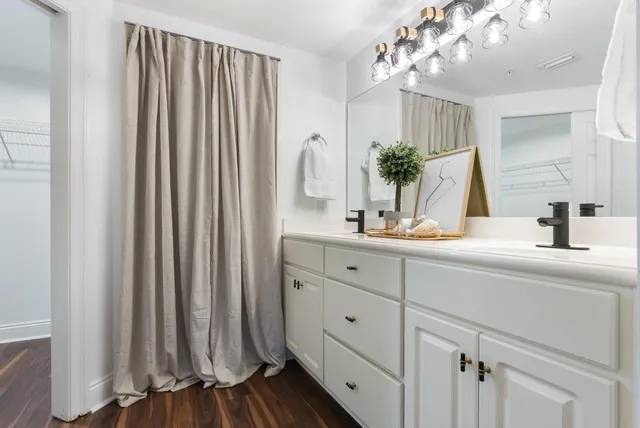 a view of a living room and kitchen with stainless steel appliances