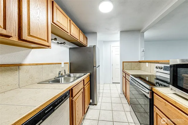 a kitchen with stainless steel appliances granite countertop a sink and a stove