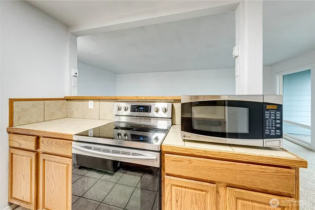 a kitchen with a stove and a microwave