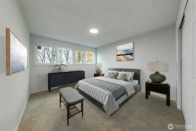 a spacious bedroom with a bed and a furniture