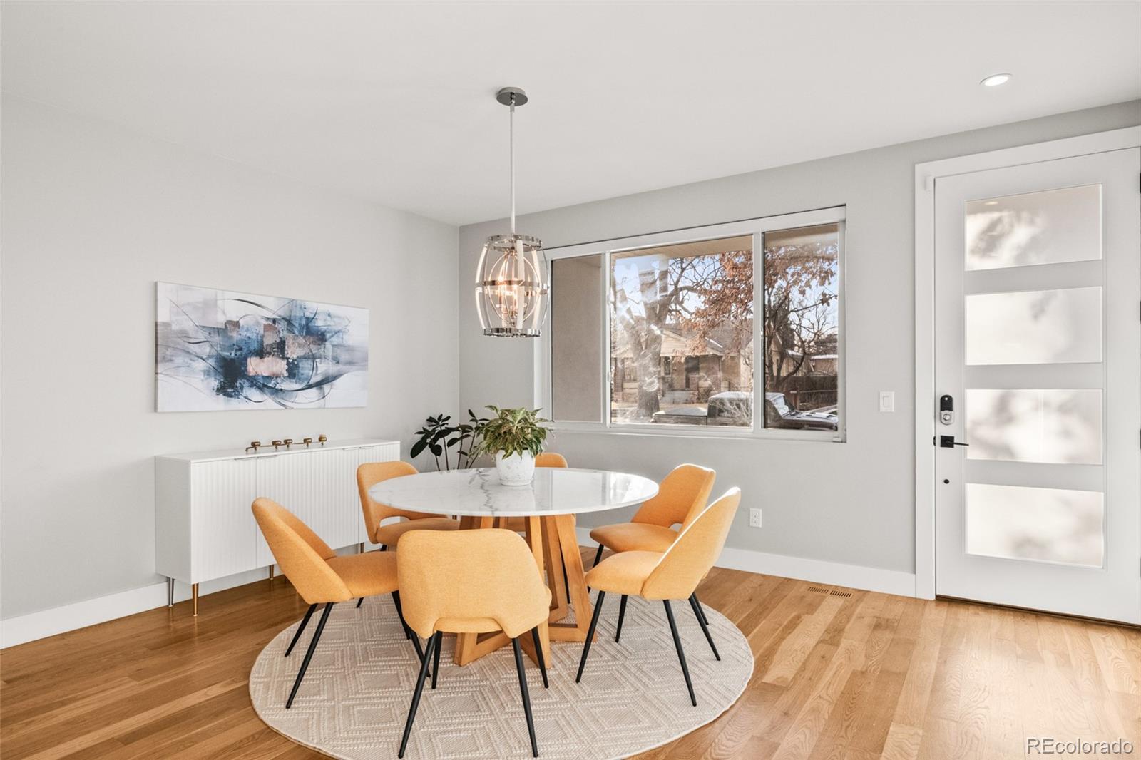 3612 Vallejo Street Denver, CO 80211 - Photo 16 of 50 a dining room with furniture a rug and wooden floor
