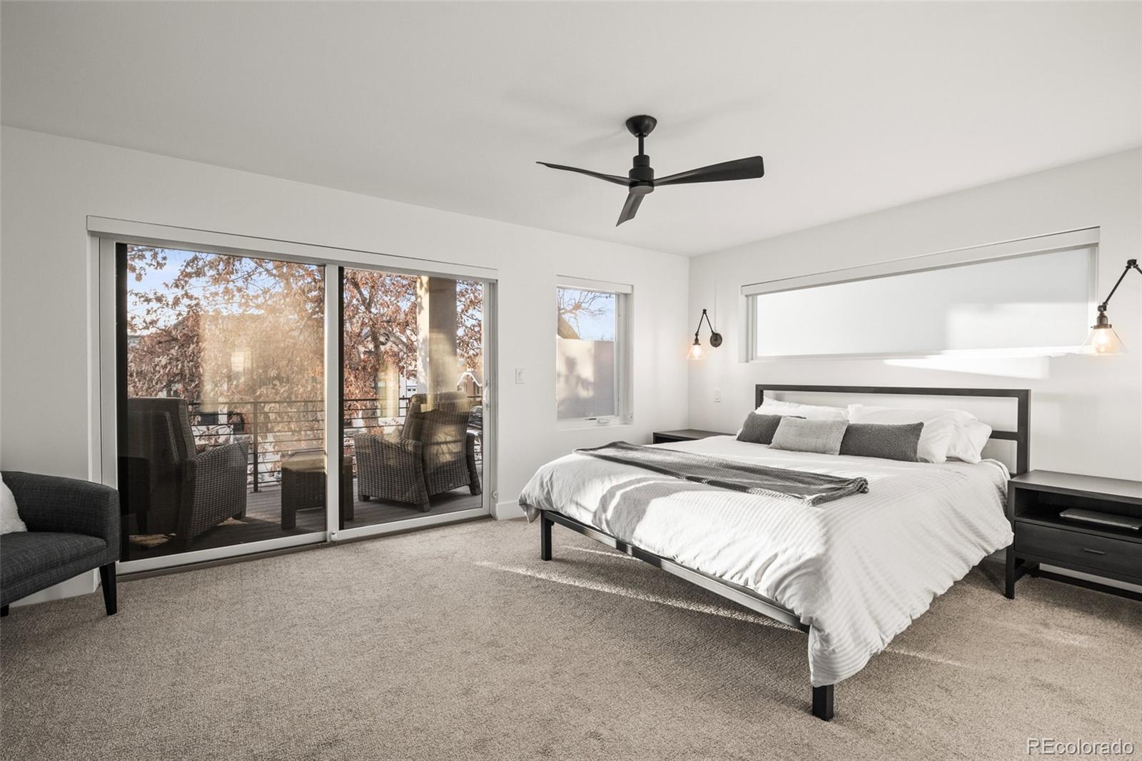 3612 Vallejo Street Denver, CO 80211 - Photo 17 of 50 a large bedroom with a large bed and a chandelier fan