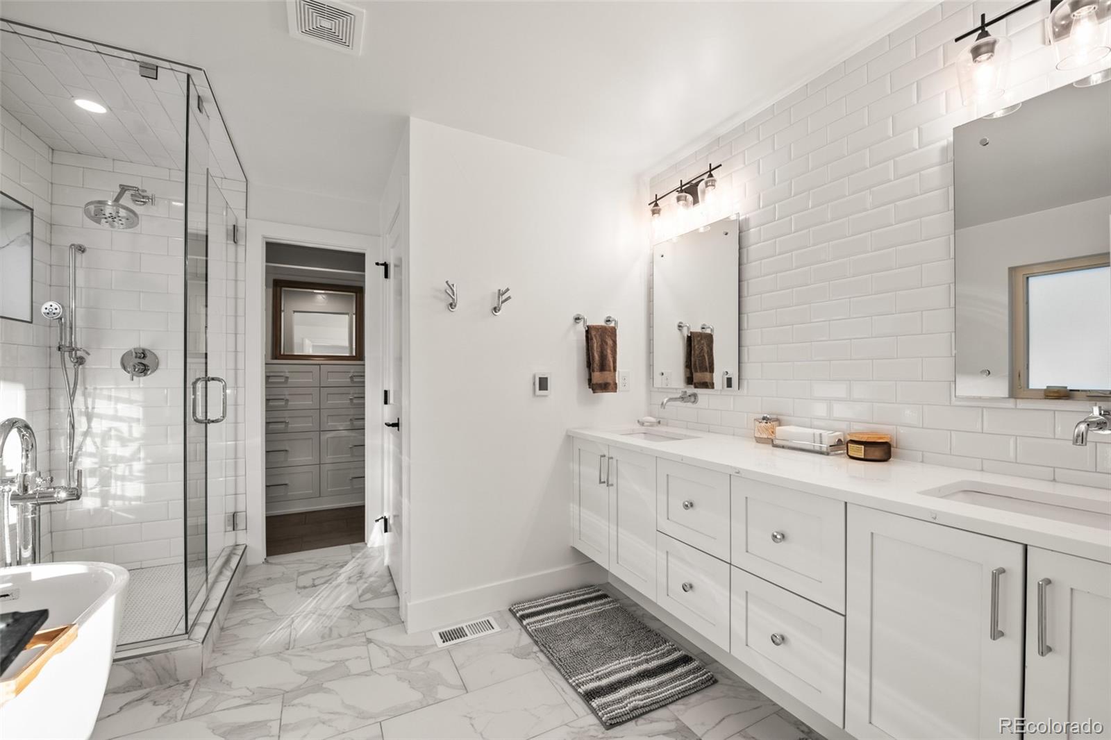 3612 Vallejo Street Denver, CO 80211 - Photo 20 of 50 a spacious bathroom with double vanity sink and a shower