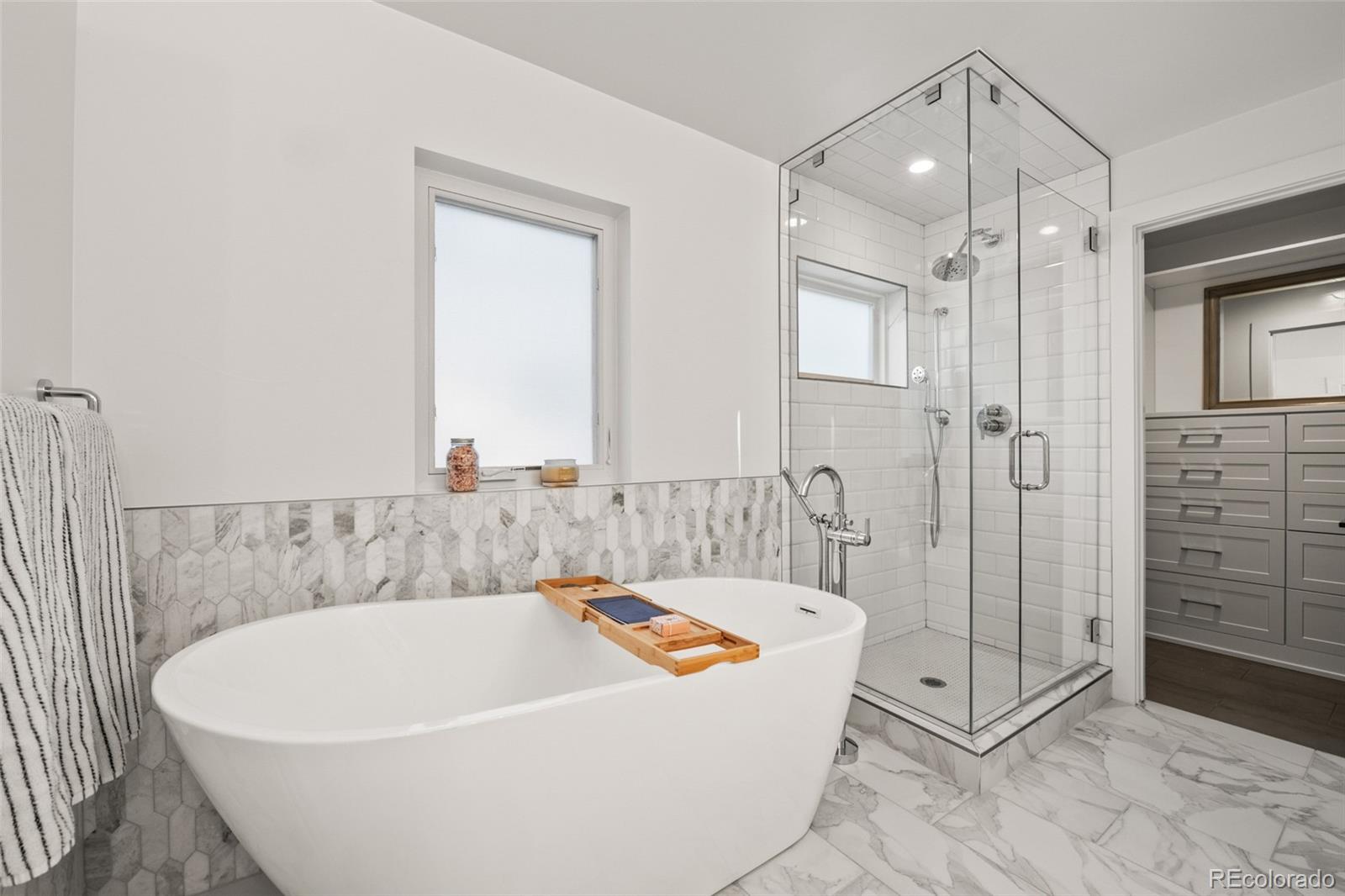 3612 Vallejo Street Denver, CO 80211 - Photo 21 of 50 a white bath tub sitting next to a shower