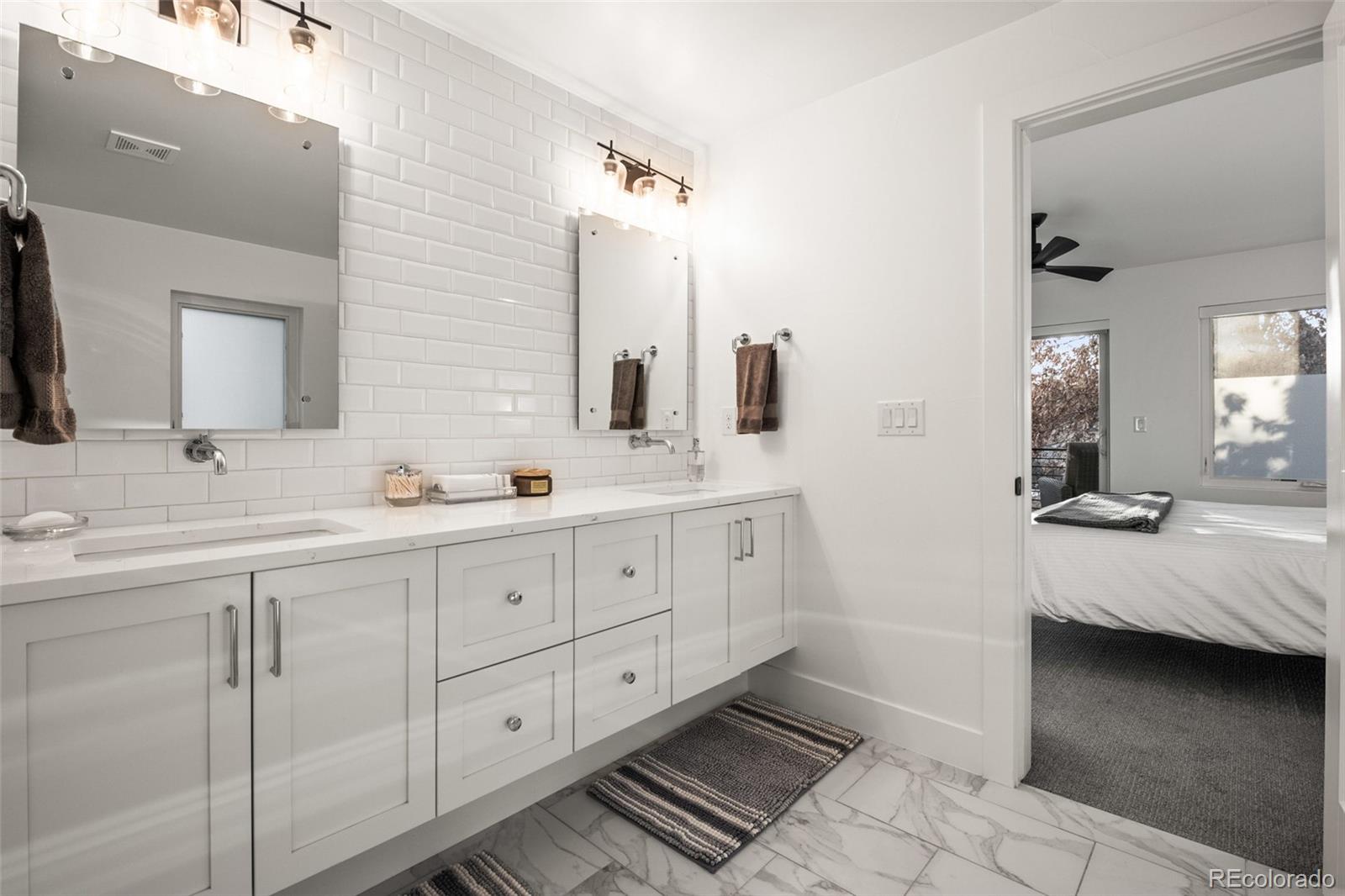 3612 Vallejo Street Denver, CO 80211 - Photo 22 of 50 a spacious bathroom with double vanity and a mirror