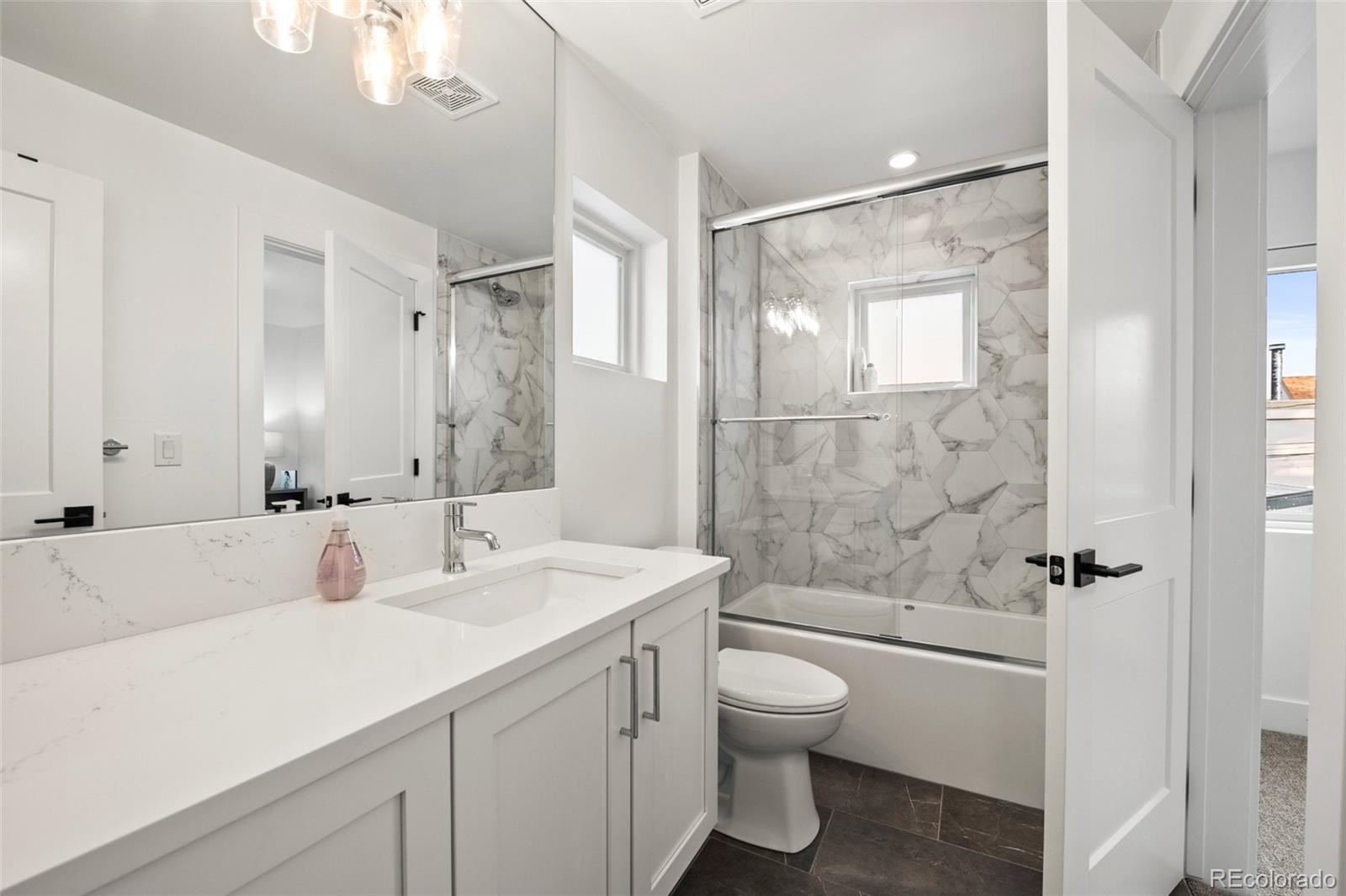 3612 Vallejo Street Denver, CO 80211 - Photo 27 of 50 a bathroom with a sink a toilet and shower
