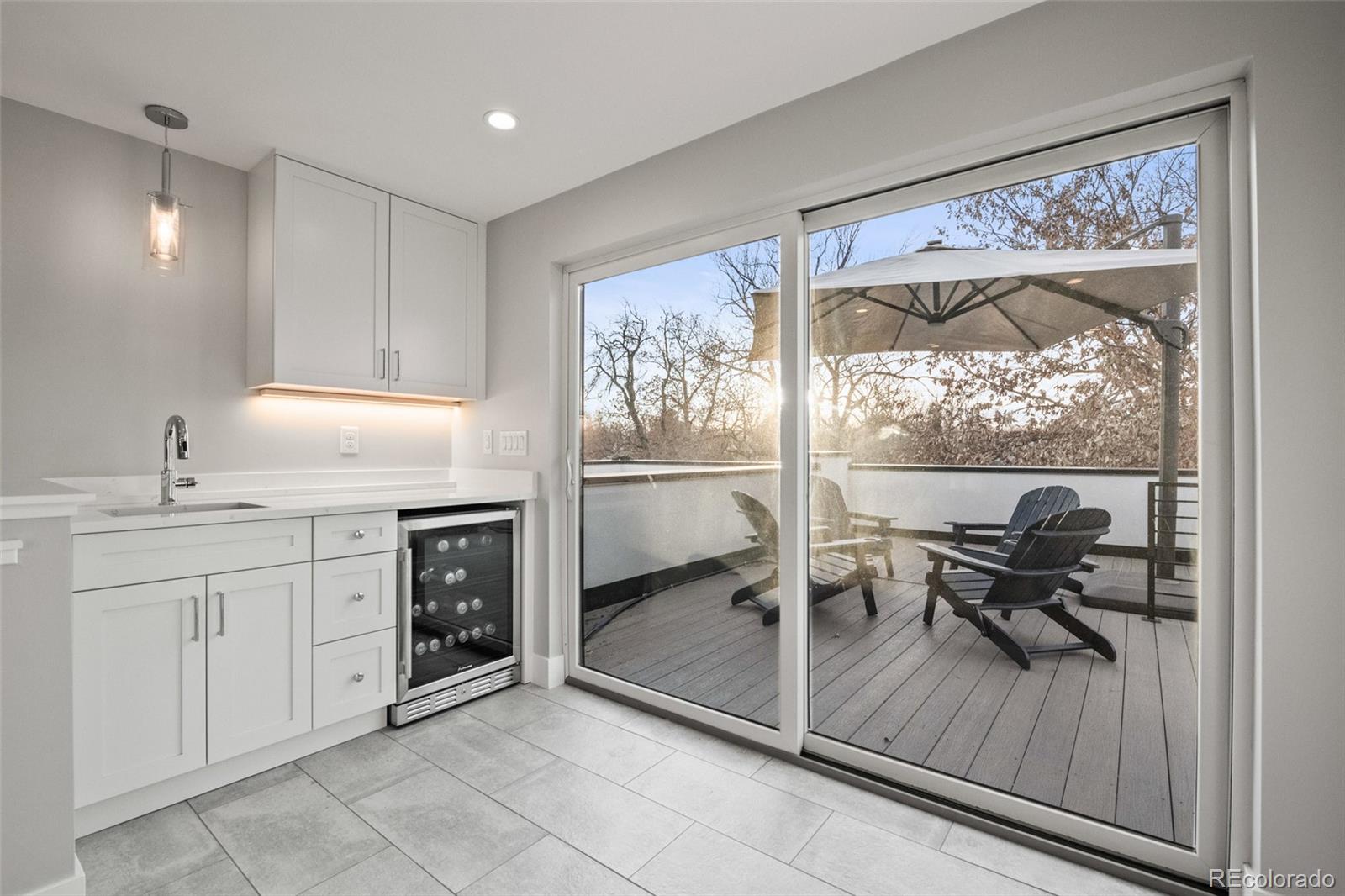 3612 Vallejo Street Denver, CO 80211 - Photo 32 of 50 a open kitchen with granite countertop a stove a sink and a table