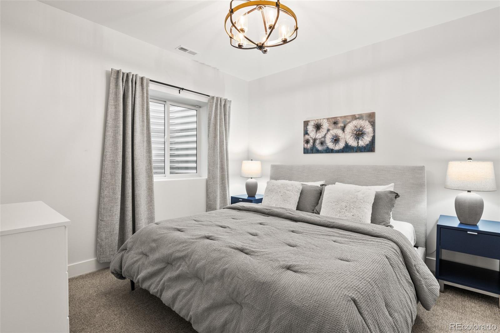 3612 Vallejo Street Denver, CO 80211 - Photo 37 of 50 a bedroom with a bed and a chandelier