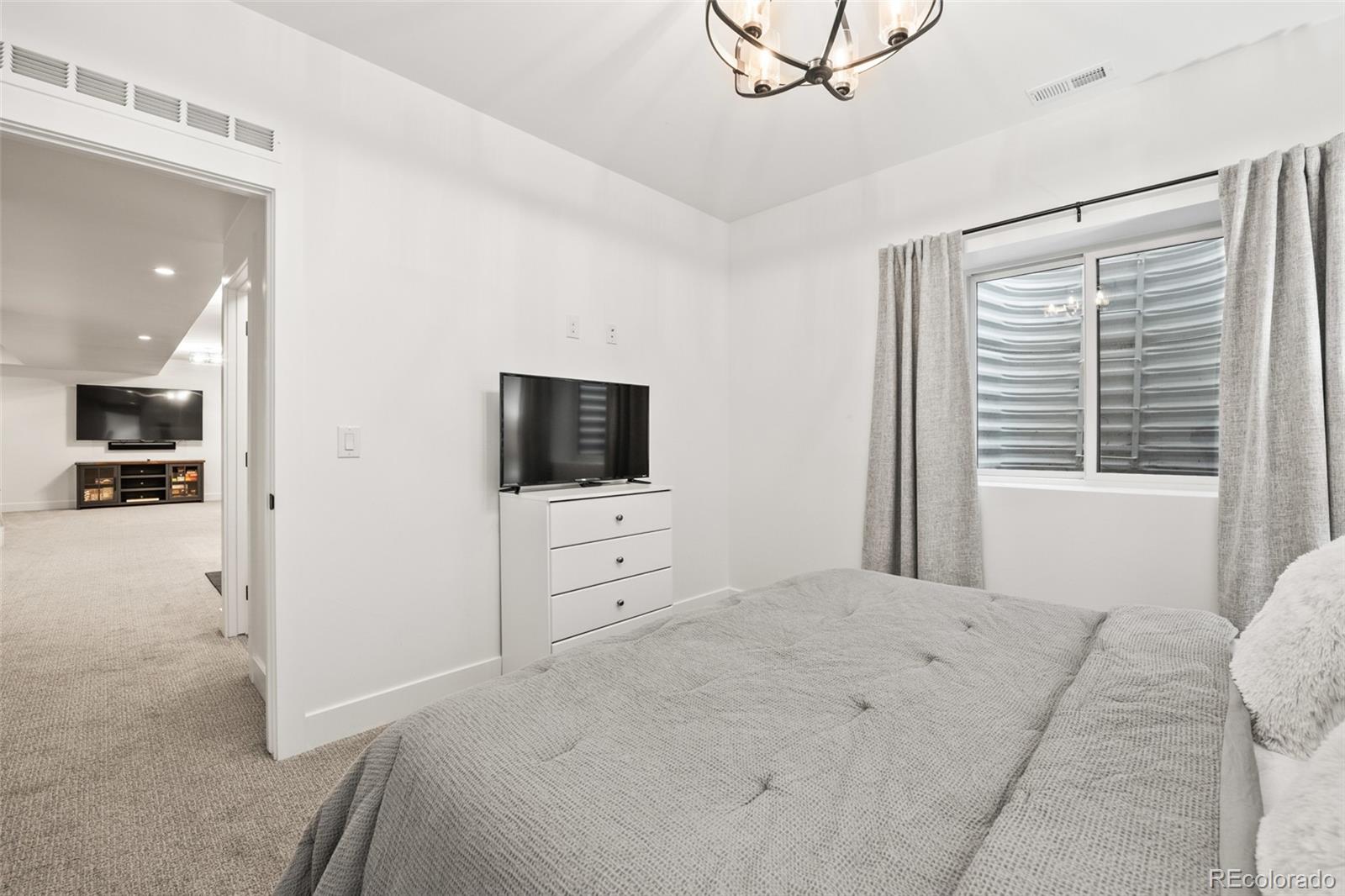 3612 Vallejo Street Denver, CO 80211 - Photo 38 of 50 a bedroom with a bed and a flat screen tv