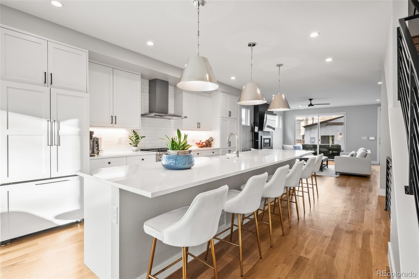 3612 Vallejo Street Denver, CO 80211 - Photo 6 of 50 a kitchen with stainless steel appliances kitchen island granite countertop a table chairs and a refrigerator