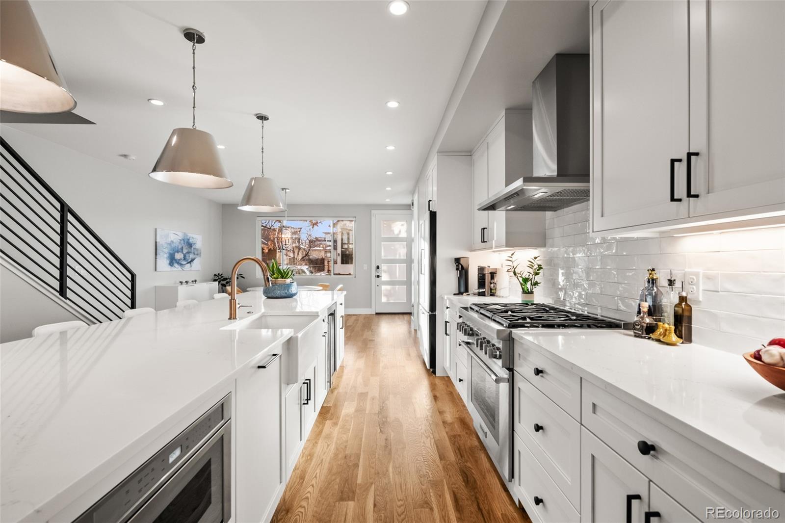 3612 Vallejo Street Denver, CO 80211 - Photo 8 of 50 a kitchen with a sink stove and wooden floor