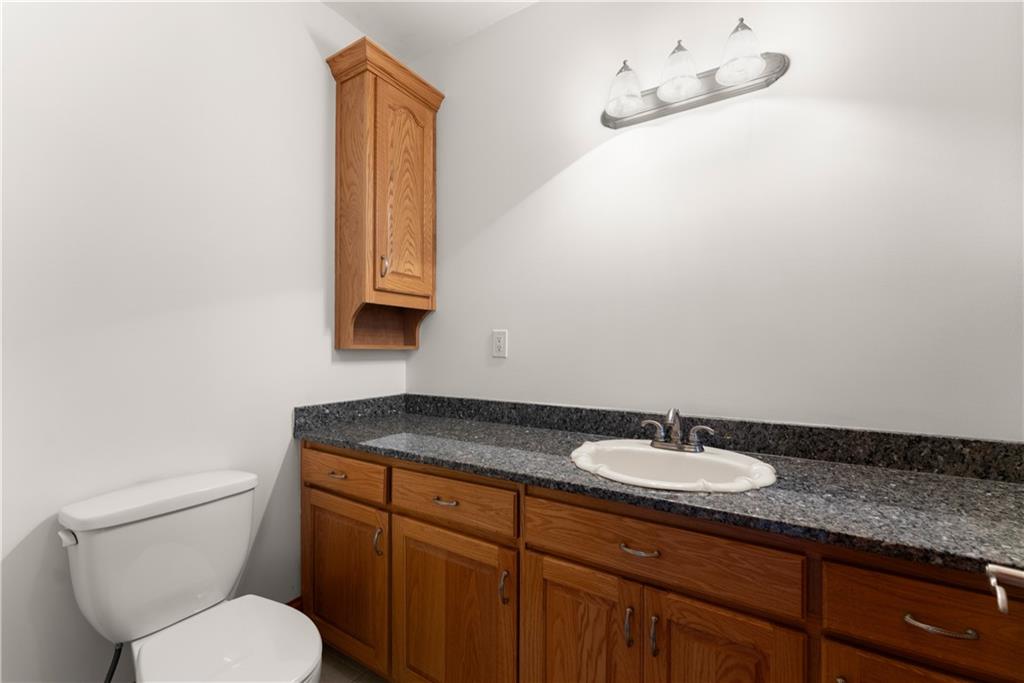 287 Spring Branch Circle Toccoa, GA 30577 - Photo 29 of 75 a bathroom with a granite countertop sink a toilet and mirror