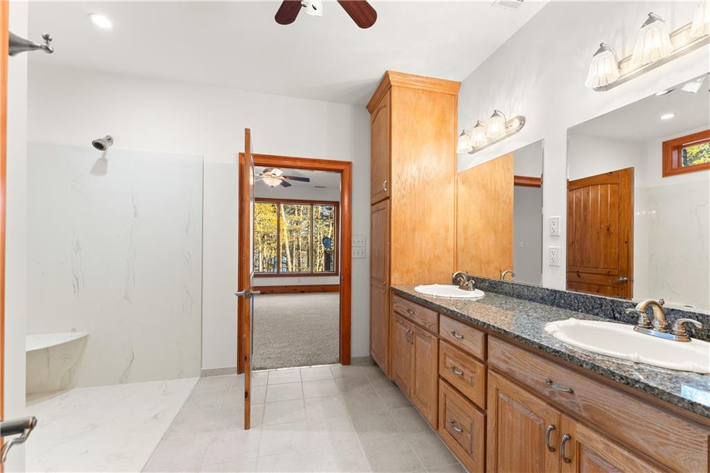 287 Spring Branch Circle Toccoa, GA 30577 - Photo 30 of 75 a spacious bathroom with a granite countertop sink and a mirror