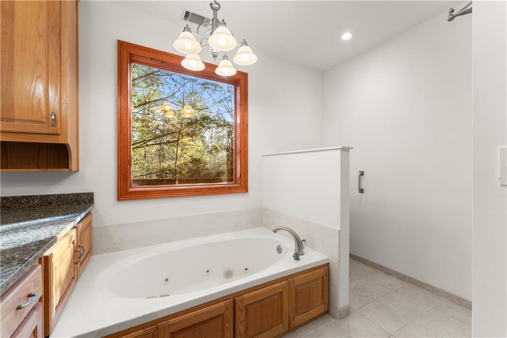 287 Spring Branch Circle Toccoa, GA 30577 - Photo 33 of 75 a bathroom with a bathtub and a shower