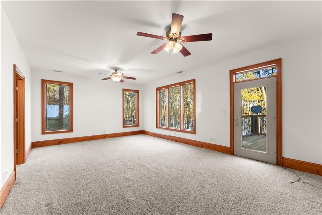 287 Spring Branch Circle Toccoa, GA 30577 - Photo 36 of 75 a view of a livingroom with a ceiling fan and windows