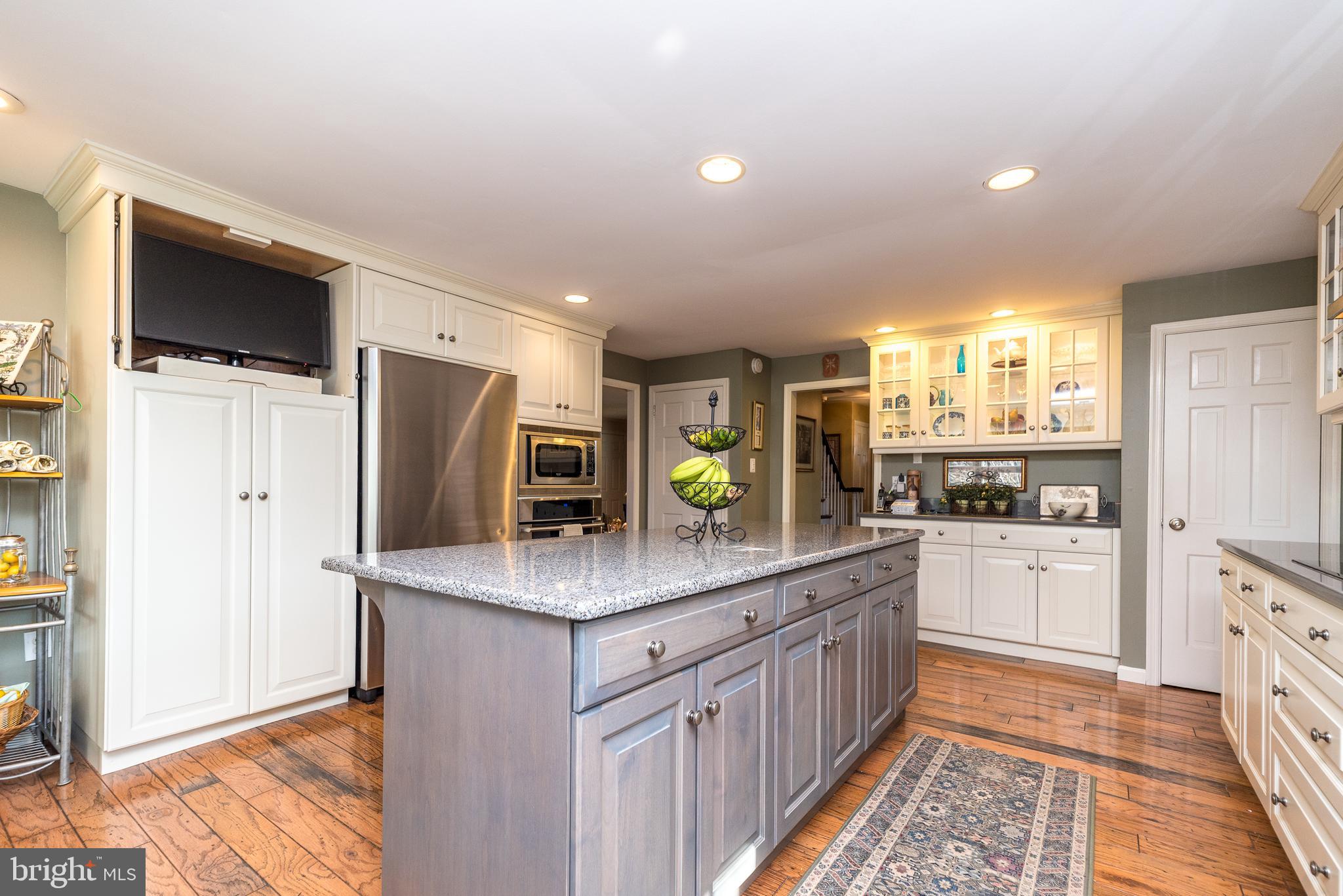 140 Short Road Doylestown, PA 18901 - Photo 11 of 34 a kitchen with stainless steel appliances kitchen island granite countertop a refrigerator and a stove top oven