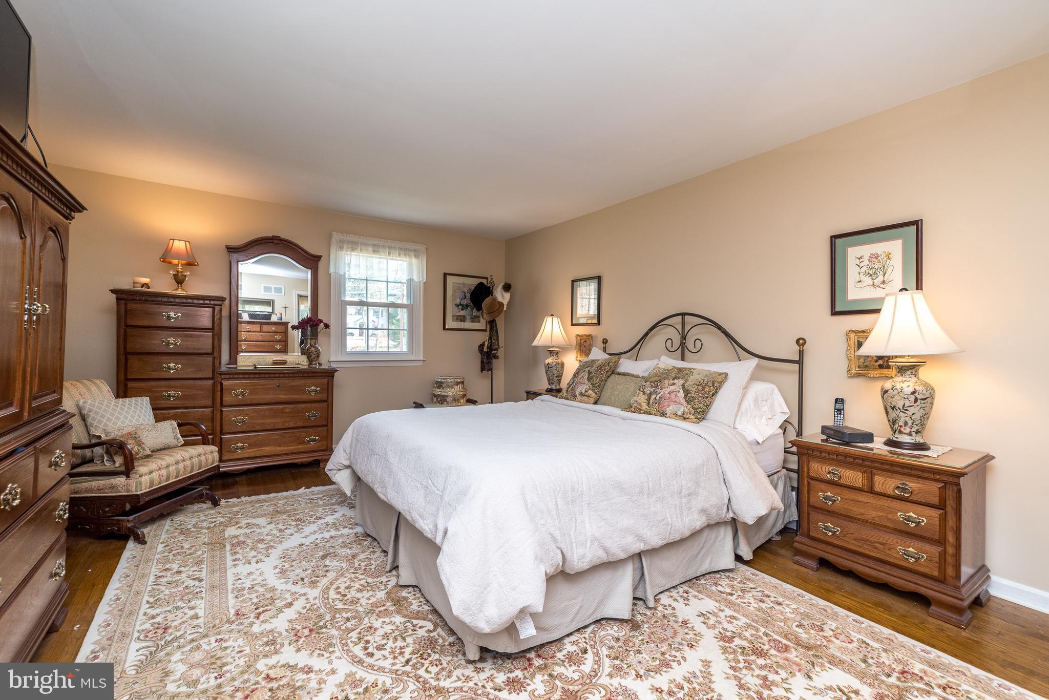 140 Short Road Doylestown, PA 18901 - Photo 20 of 34 a bedroom with a bed and a lamp on dresser