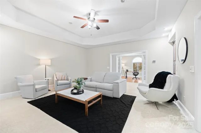 a living room with furniture a rug and a chandelier