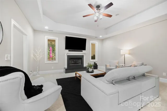 a living room with furniture a fireplace and a flat screen tv