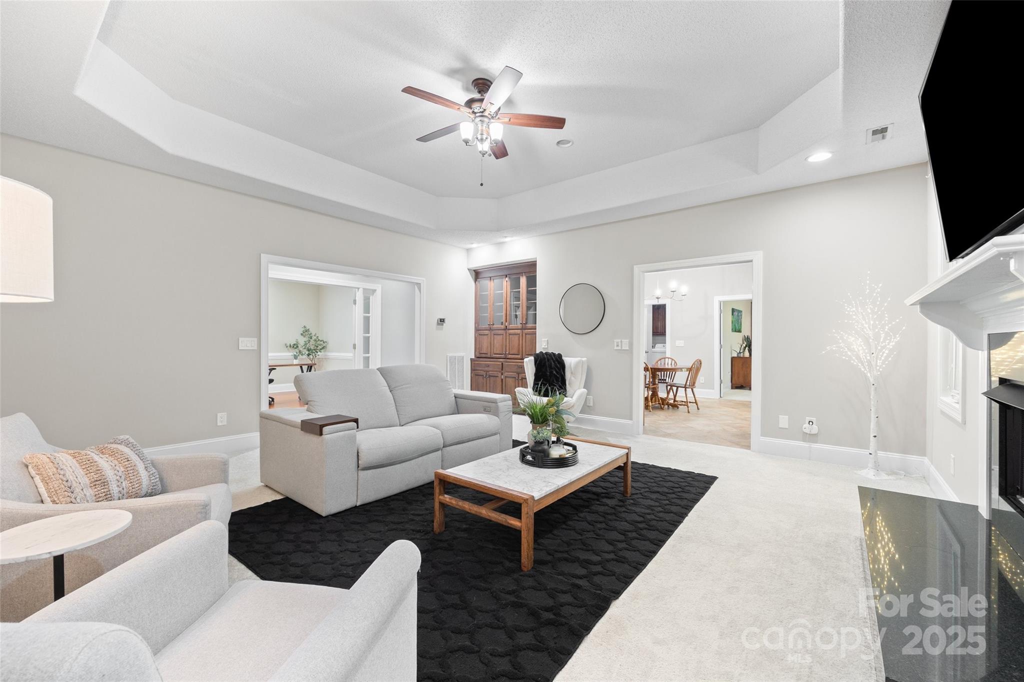 3559 Nestling Lane Fort Mill, SC 29708 - Photo 13 of 42 a living room with furniture a fireplace and a chandelier