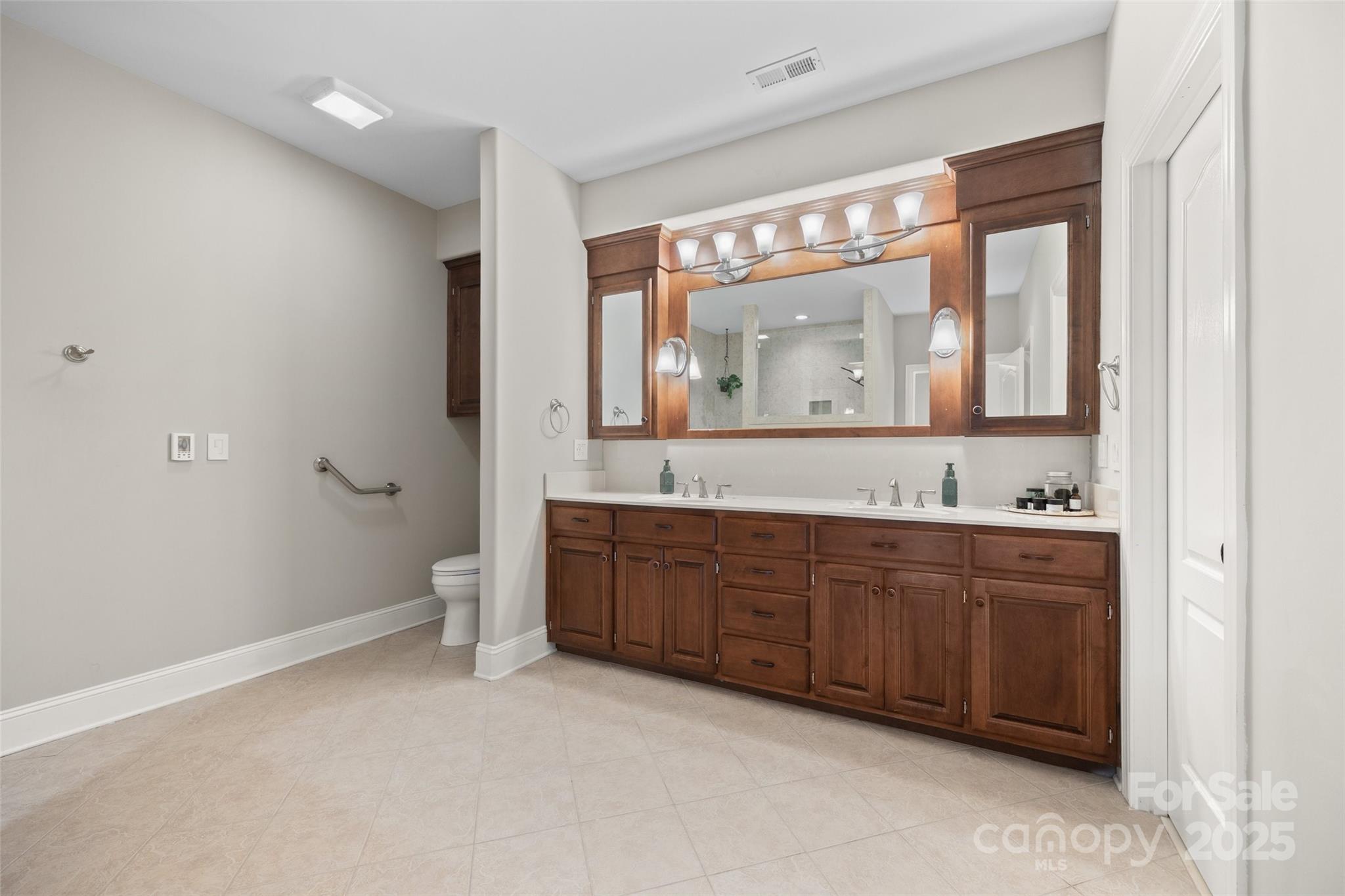 3559 Nestling Lane Fort Mill, SC 29708 - Photo 16 of 42 a spacious bathroom with a granite countertop sink mirror and a toilet