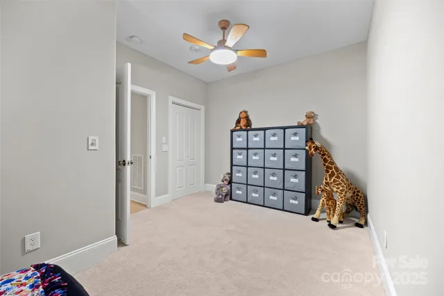 an empty room with windows and ceiling fan