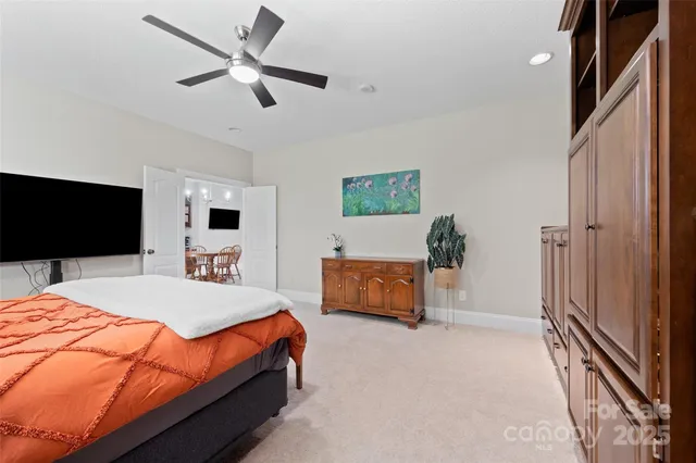 a bedroom with a bed a window and a flat screen television