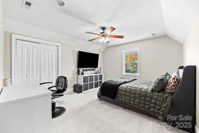 a bedroom with furniture and a window