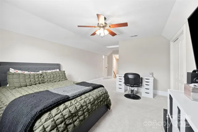 a bedroom with a bed and ceiling fan