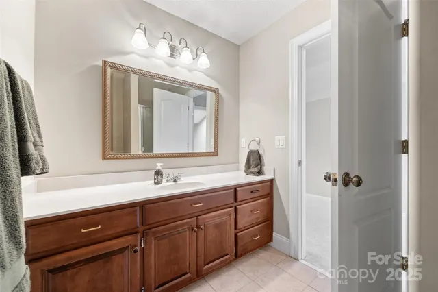 a bathroom with a double vanity sink and mirror with shower