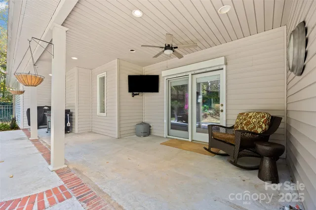 a view of a livingroom with furniture and a flat screen tv