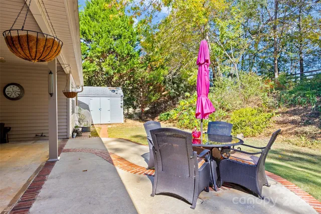 a view of a patio with a table and chairs
