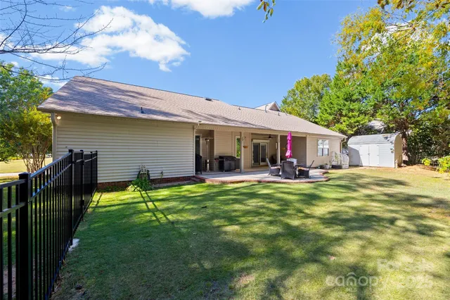 a view of a house with backyard and sitting area