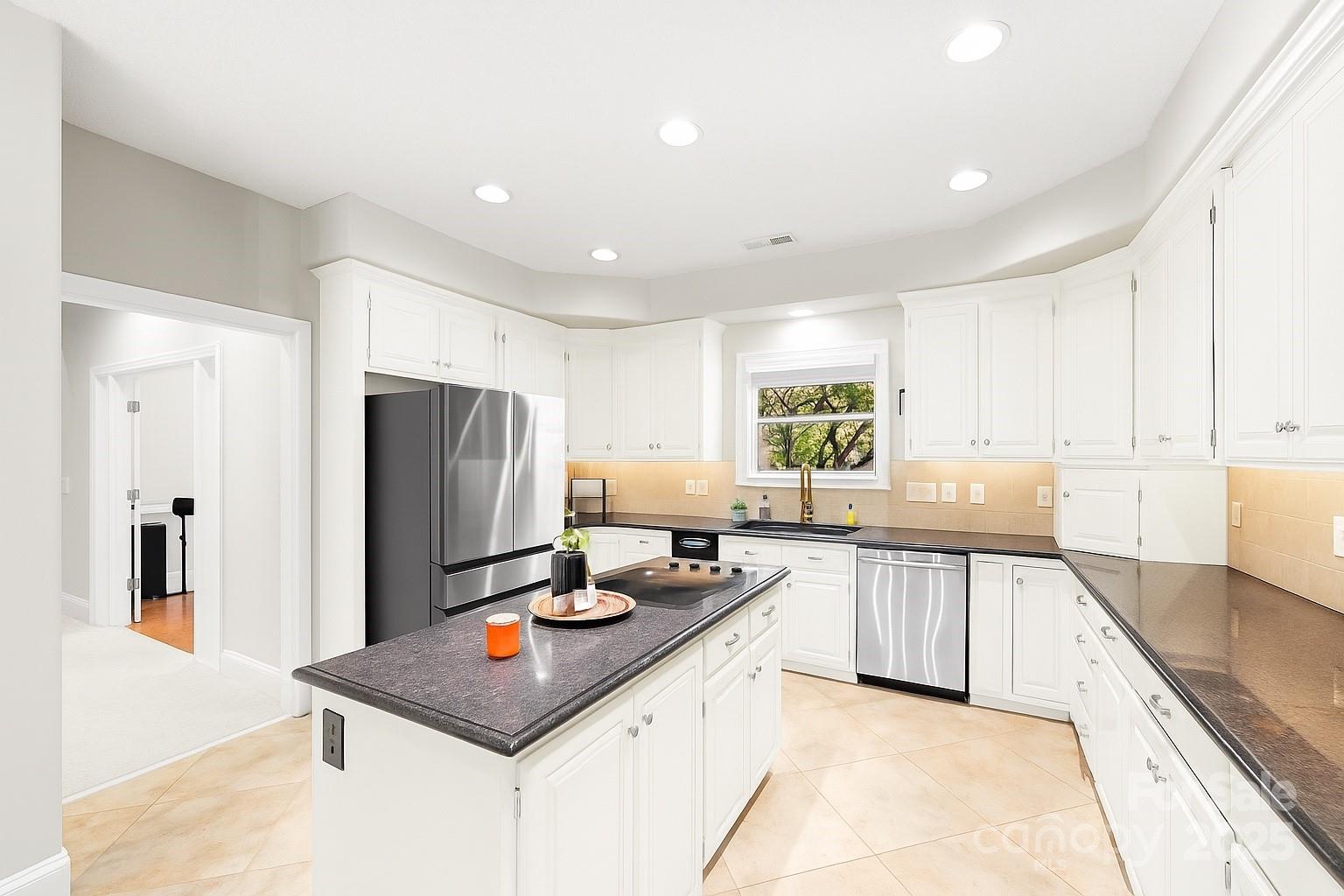 3559 Nestling Lane Fort Mill, SC 29708 - Photo 6 of 42 a kitchen with stainless steel appliances granite countertop a sink refrigerator and cabinets
