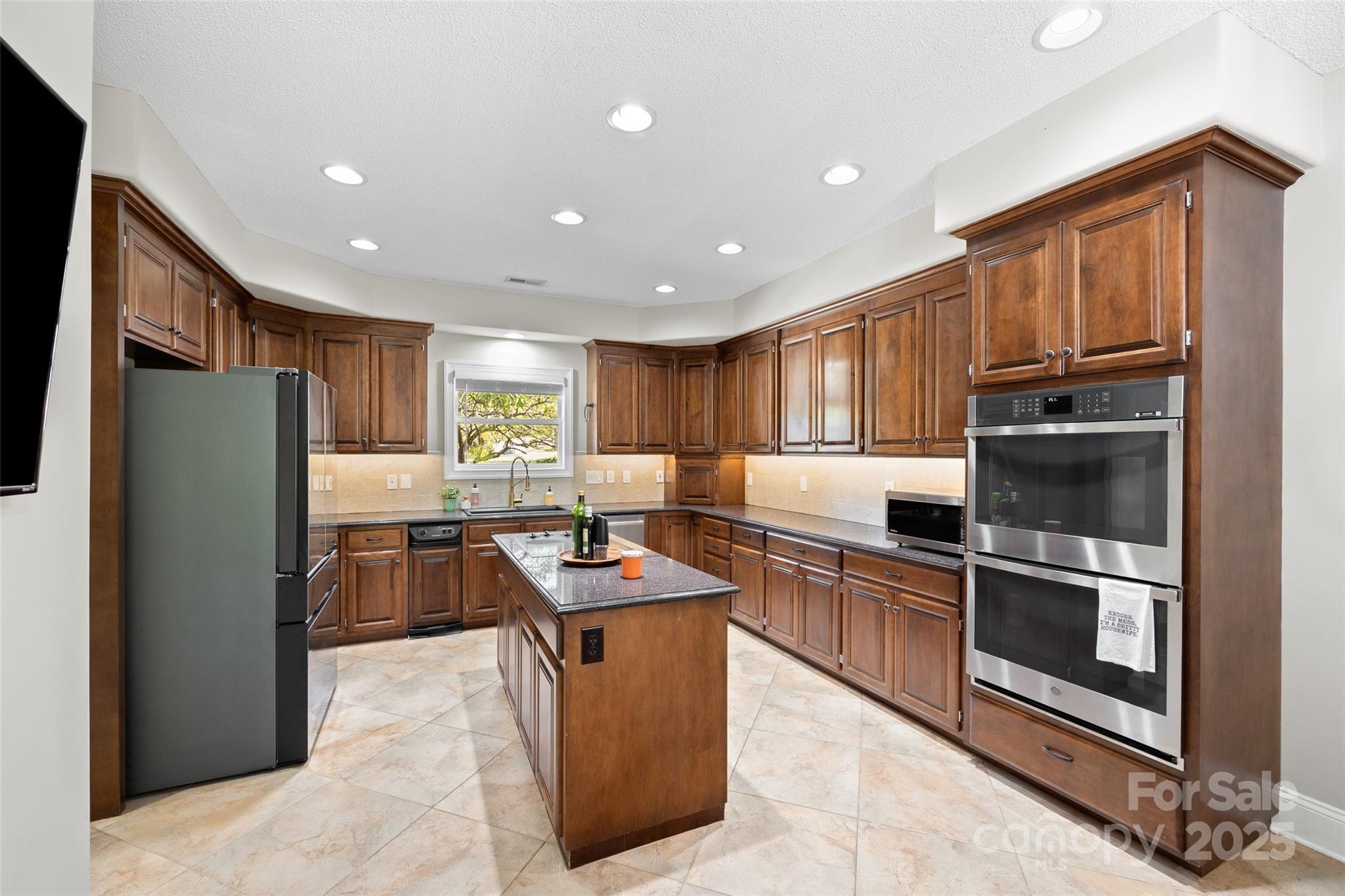 3559 Nestling Lane Fort Mill, SC 29708 - Photo 7 of 42 a kitchen with stainless steel appliances granite countertop a refrigerator stove and oven