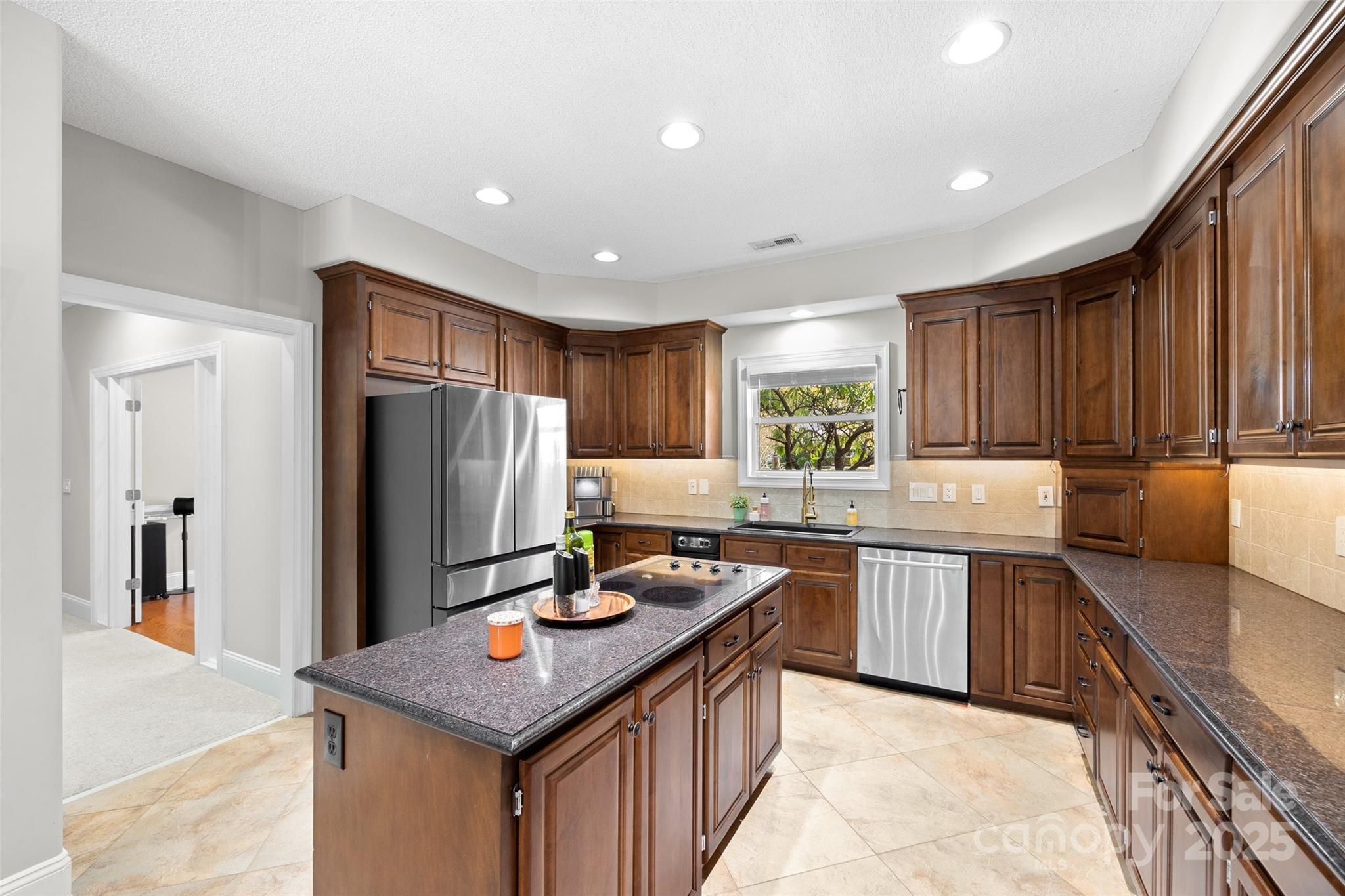 3559 Nestling Lane Fort Mill, SC 29708 - Photo 8 of 42 a kitchen with stainless steel appliances granite countertop a stove refrigerator sink and cabinets