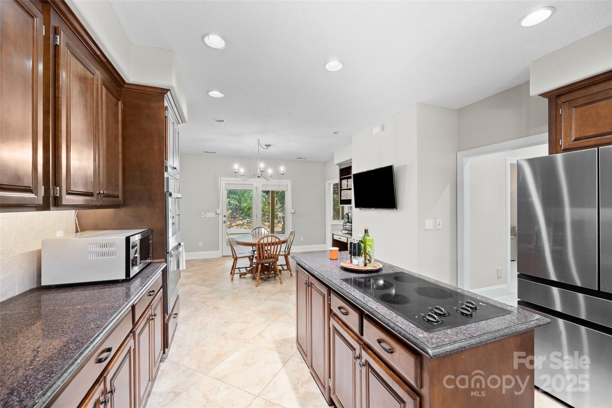3559 Nestling Lane Fort Mill, SC 29708 - Photo 9 of 42 a living room with stainless steel appliances furniture and a kitchen view