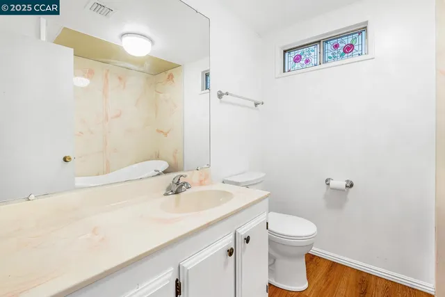 a view of a livingroom with a ceiling fan and window