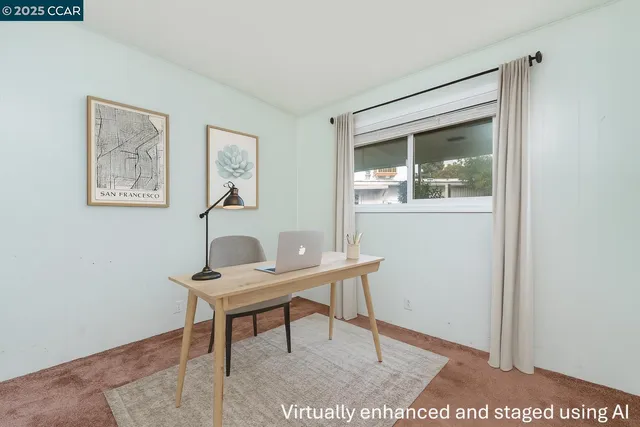 a view of patio with table and chairs under an umbrella with a small yard