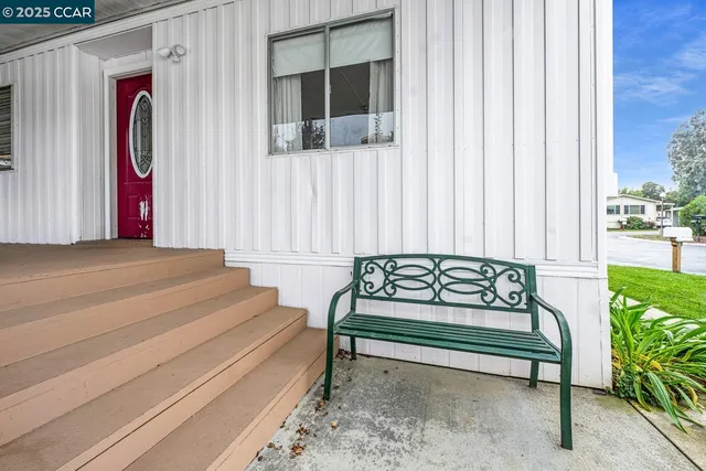 a view of a chair and tables in the backyard