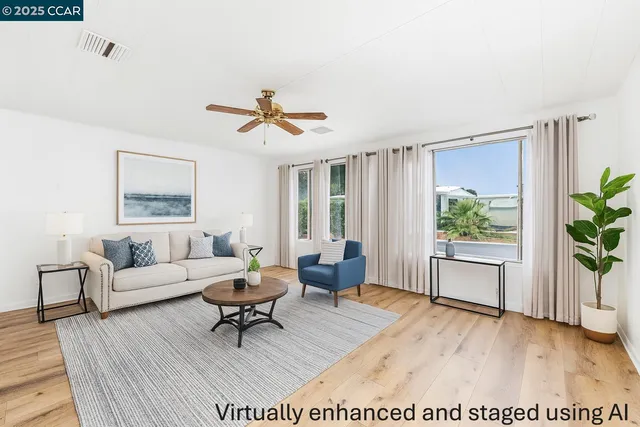 a view of empty room with wooden floor and ceiling fan