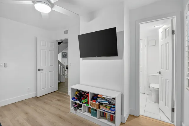a bathroom with a granite countertop sink mirror vanity and toilet