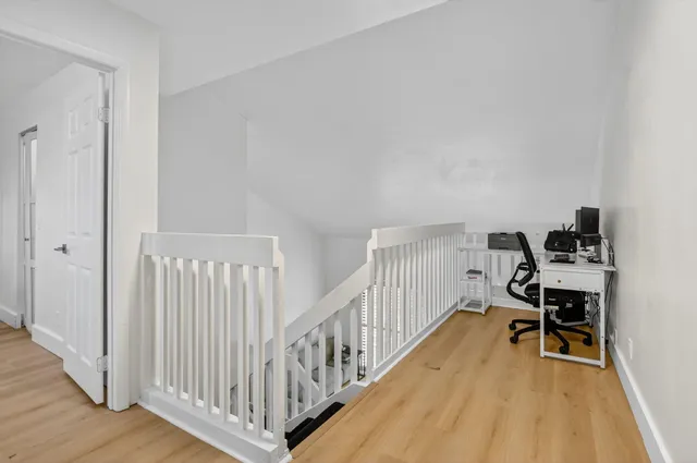 a balcony view with two chairs and a table