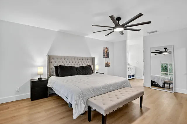 a view of a yard with plants and a bench