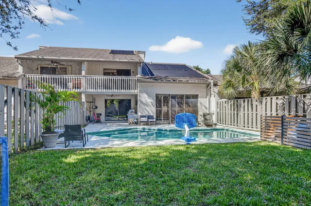 an aerial view of residential houses with outdoor space and street view