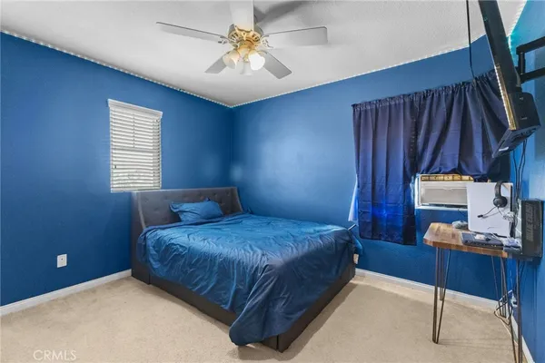 a bedroom with two beds and a window