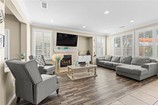 a living room with furniture a fireplace and a flat screen tv